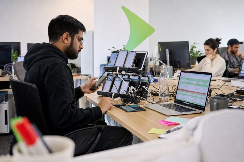 A Glober thinking through a problem in front of a laptop